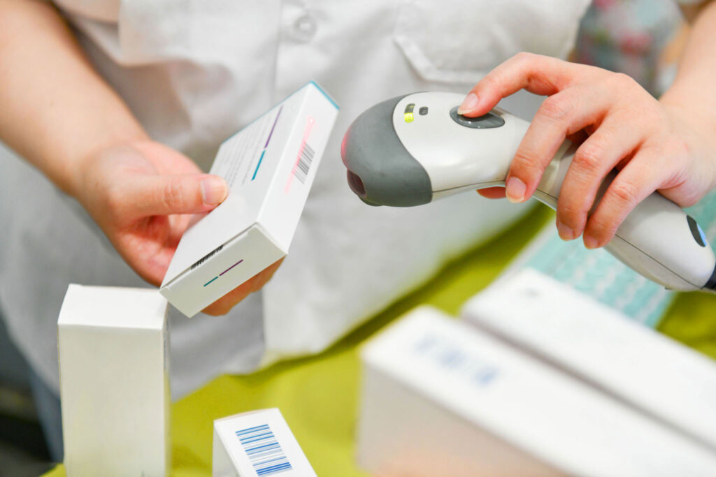 pharmacist scanning a prescription box